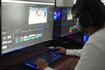 Man sitting at desk with monitor in front of him